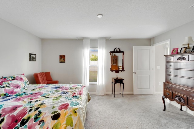 carpeted bedroom featuring a textured ceiling