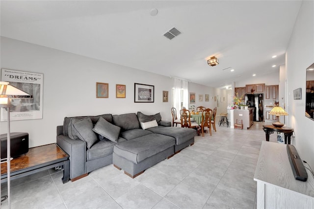 living room featuring light tile patterned flooring and lofted ceiling