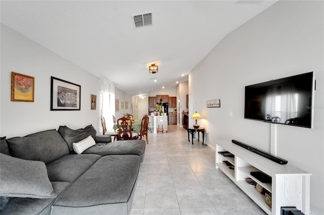 living room with light tile patterned floors and lofted ceiling