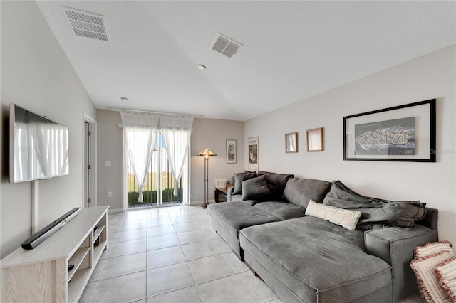 tiled living room featuring vaulted ceiling