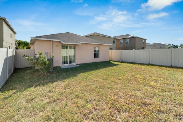 rear view of house with a yard