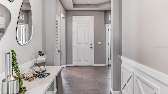 entrance foyer featuring dark tile patterned flooring