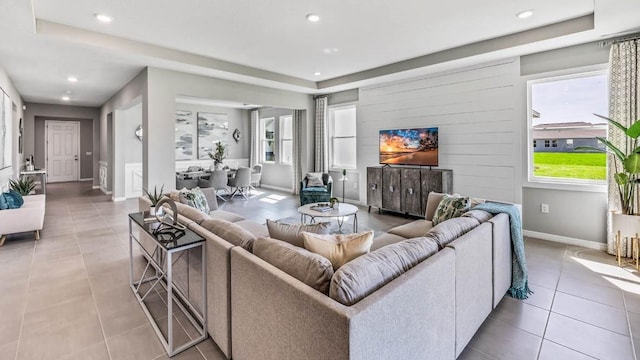 tiled living room with a raised ceiling