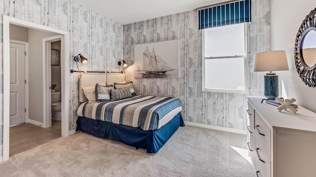 carpeted bedroom featuring ensuite bathroom