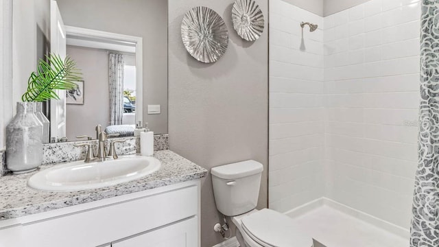 bathroom featuring vanity, toilet, and curtained shower