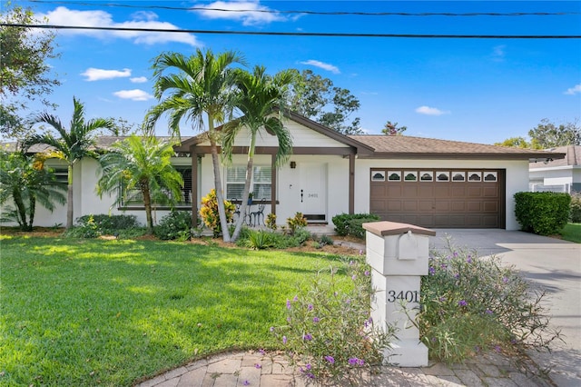 ranch-style house featuring a garage and a front yard