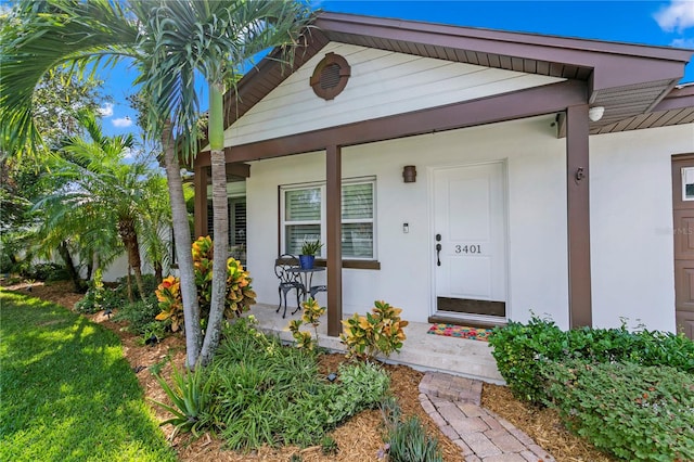 view of exterior entry with a porch