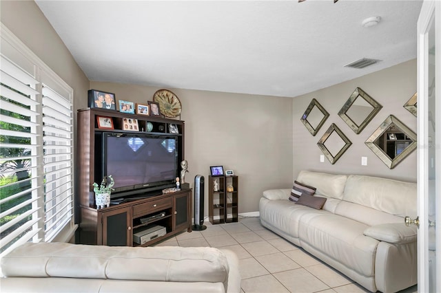 living room with light tile patterned floors and a textured ceiling