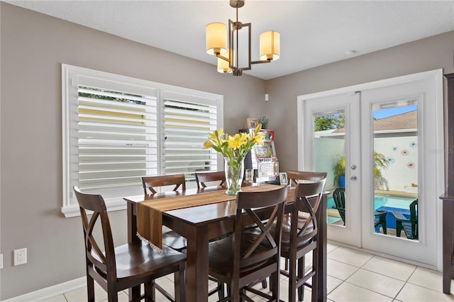 dining room featuring french doors, light tile patterned floors, a chandelier, and a textured ceiling