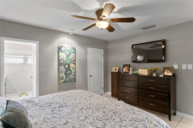 bedroom featuring light tile patterned floors, connected bathroom, and ceiling fan