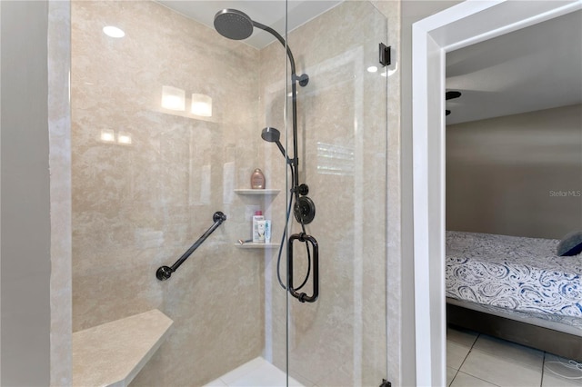 bathroom featuring tile patterned flooring and a shower with shower door