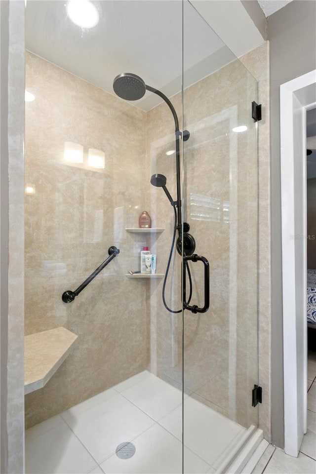 bathroom featuring tile patterned flooring and an enclosed shower