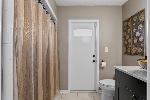 bathroom with tile patterned flooring, vanity, and toilet