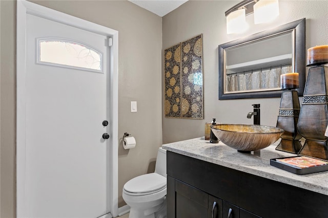 bathroom featuring vanity and toilet