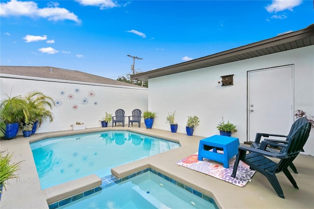 view of swimming pool featuring an in ground hot tub