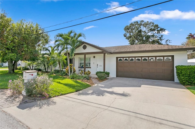 view of front of property with a garage and a front lawn