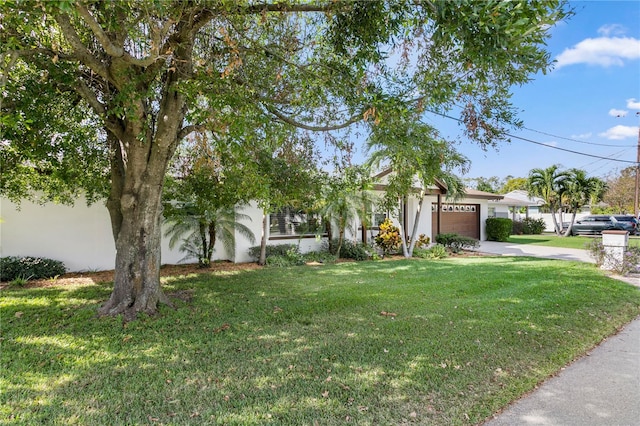 view of front of house featuring a front yard and a garage