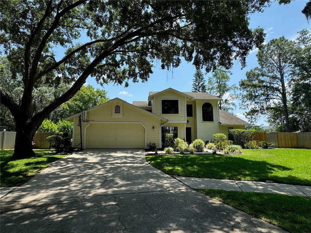 view of front of property featuring a front yard and a garage