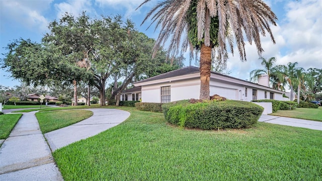 view of side of property with a lawn