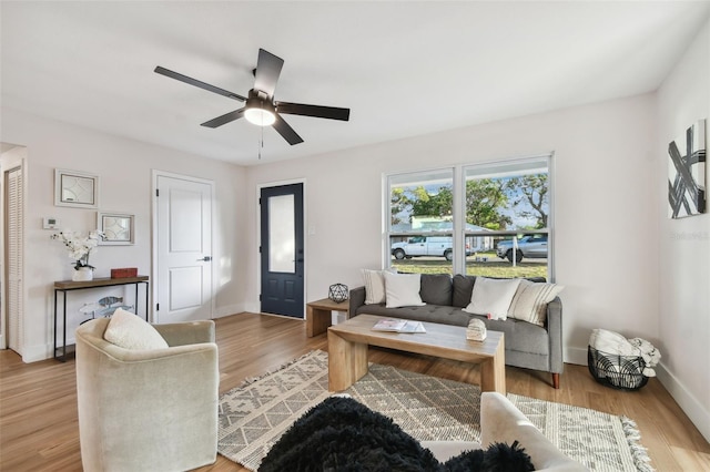 living room with ceiling fan and light wood-type flooring