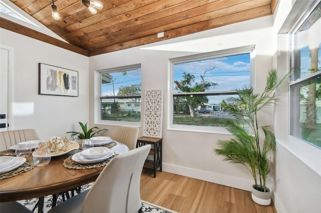 dining area featuring wood ceiling, lofted ceiling, and light wood-type flooring