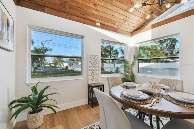 dining space featuring light hardwood / wood-style flooring, wood ceiling, and lofted ceiling