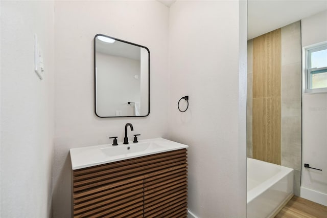 bathroom featuring separate shower and tub, vanity, and wood-type flooring