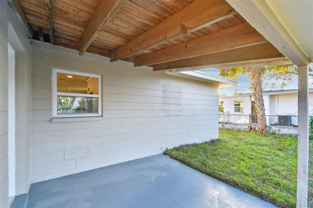 view of side of property with a lawn and a patio area