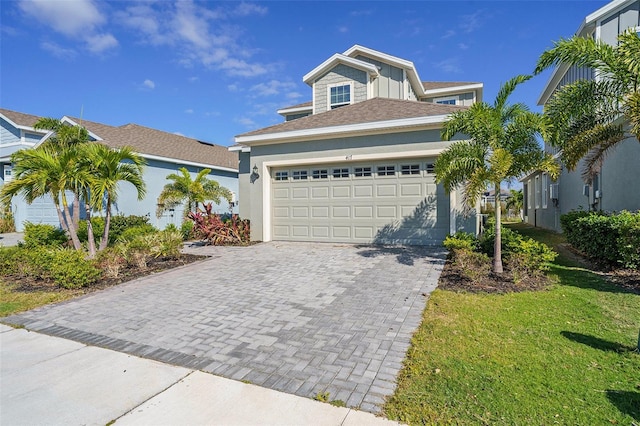 view of front of home featuring a front yard and a garage