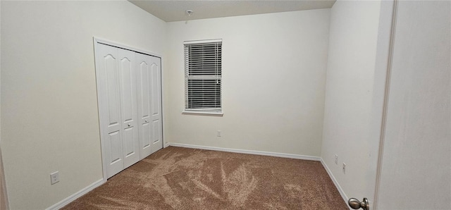 unfurnished bedroom with carpet flooring and a closet