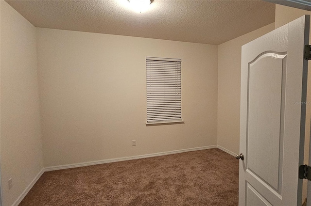 carpeted spare room featuring a textured ceiling