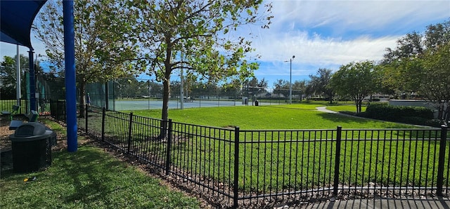 surrounding community with a lawn and tennis court