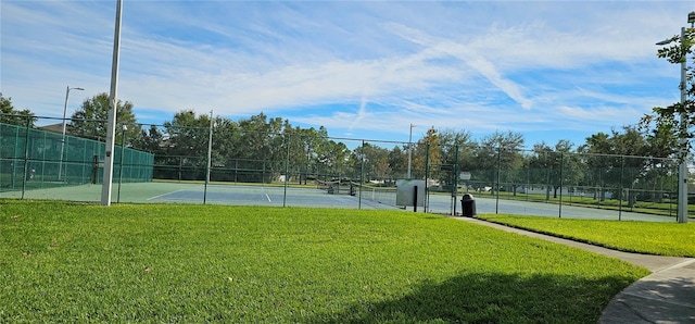 view of tennis court with a lawn