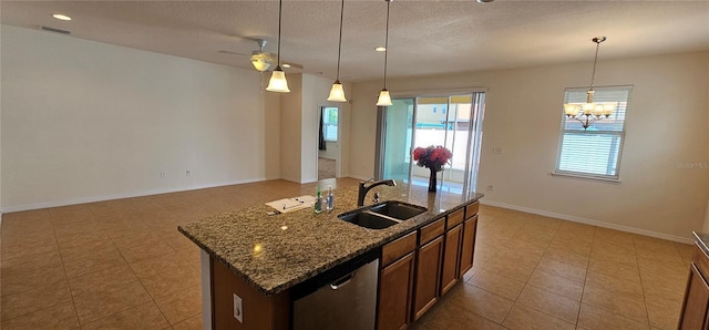 kitchen with dishwasher, a kitchen island with sink, sink, and hanging light fixtures