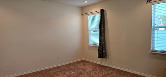 carpeted empty room with a wealth of natural light