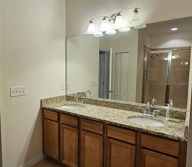 bathroom featuring vanity and a shower with shower door