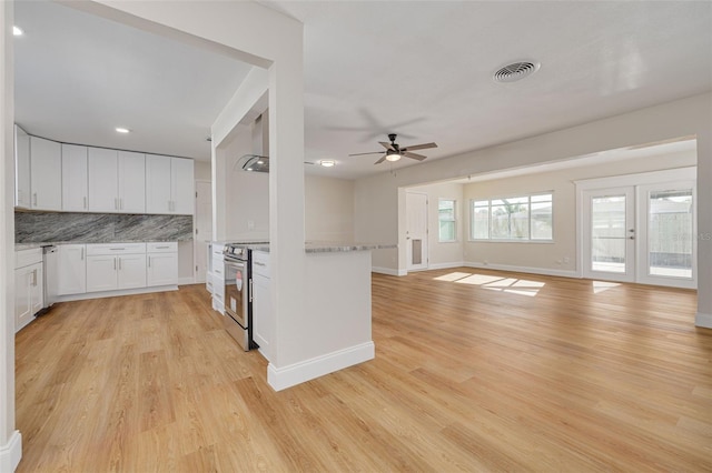 kitchen featuring ceiling fan, light hardwood / wood-style flooring, stainless steel electric range, decorative backsplash, and white cabinets