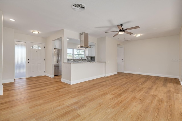 unfurnished living room with light hardwood / wood-style flooring, ceiling fan, and sink