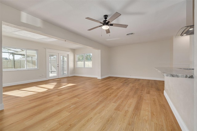 unfurnished living room featuring light hardwood / wood-style flooring and ceiling fan