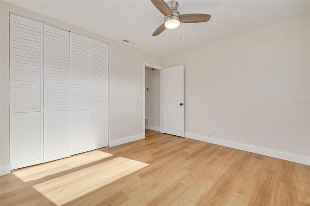 unfurnished bedroom with a closet, hardwood / wood-style floors, and ceiling fan