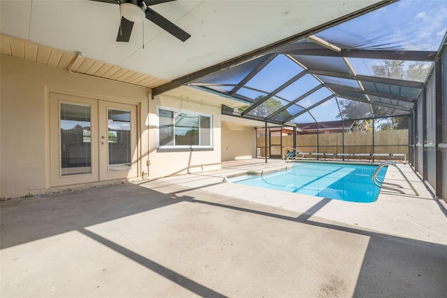 view of swimming pool featuring ceiling fan, a patio, and a lanai