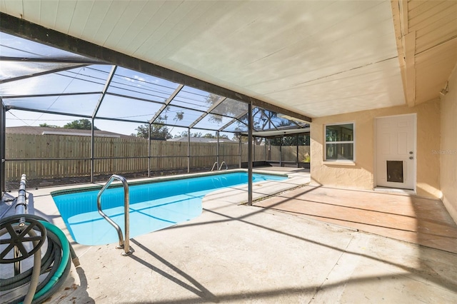 view of pool featuring glass enclosure and a patio area