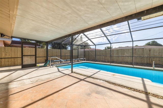 view of swimming pool featuring a patio area and a lanai