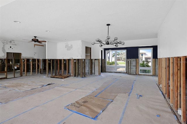 interior space with ceiling fan with notable chandelier