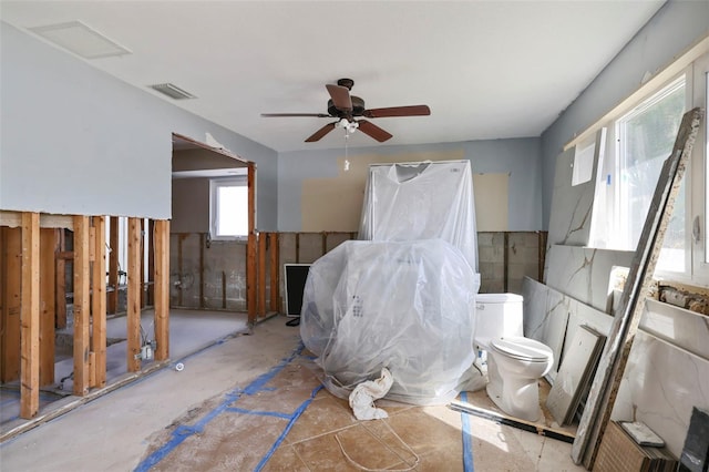 bathroom featuring ceiling fan and toilet