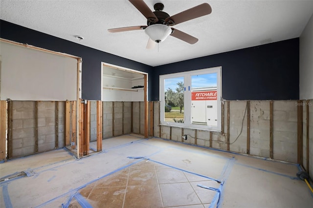 spare room featuring a textured ceiling and ceiling fan