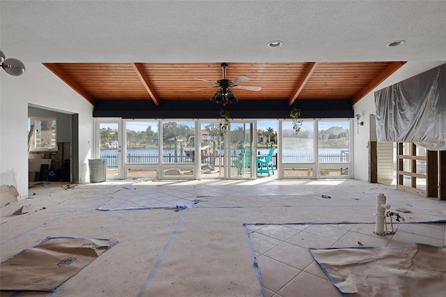 view of swimming pool with ceiling fan and a water view