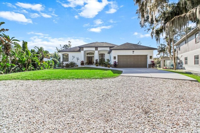 view of front of property featuring a garage and a front lawn