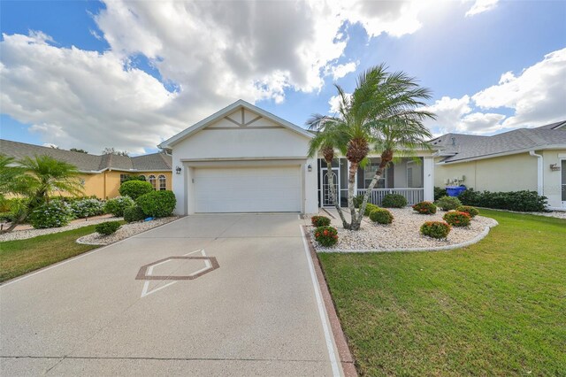 1120 Emerald Dunes Dr, Sun City Center, FL 33573 - single story home featuring an attached garage, driveway, a front yard, stucco siding, and a porch