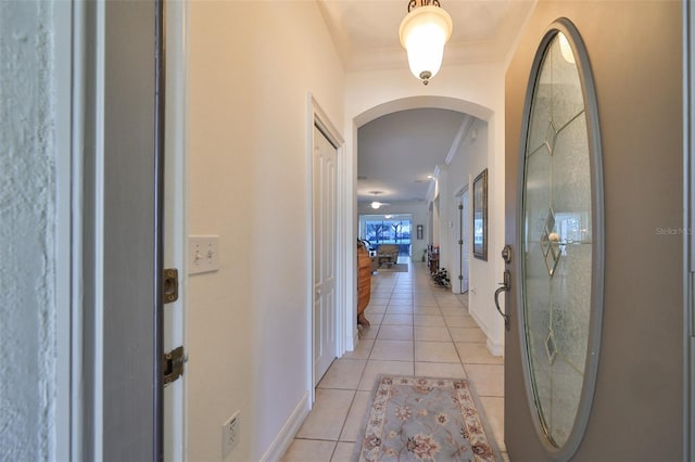 1120 Emerald Dunes Dr, Sun City Center, FL 33573 - foyer featuring arched walkways, crown molding, light tile patterned floors, and baseboards